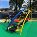 Arched climber with two bright blue arched beams linked with a black rubber belt and multiple climbers in red and yellow