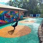 outdoor play area with spinning chair and inground circular trampoline