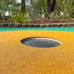 inground trampoline circular in shape installed in rubber surfacing