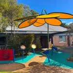 yellow flower shade over sensory musical play area