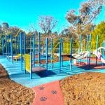 Old school playground with new rubber surfacing with bark mulch border