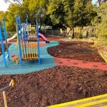 Old school playground with new rubber surfacing and bark mulch