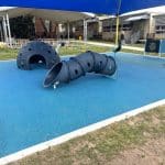 Blue rubber surfacing with blue wiggle crawl tunnel and blue dome climber