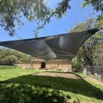 steel framed shade structure over sandpit area with charcoal coloured shade cloth canopy