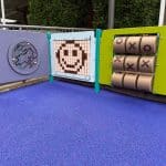 Multiple sensory panels set in a corner design in rubber wetpour surfacing, calming colours have been used with a smiley face on one of the panels.