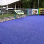 sensory play area with sensory panels and outdoor muscial pieces including a large xylophone board and drum